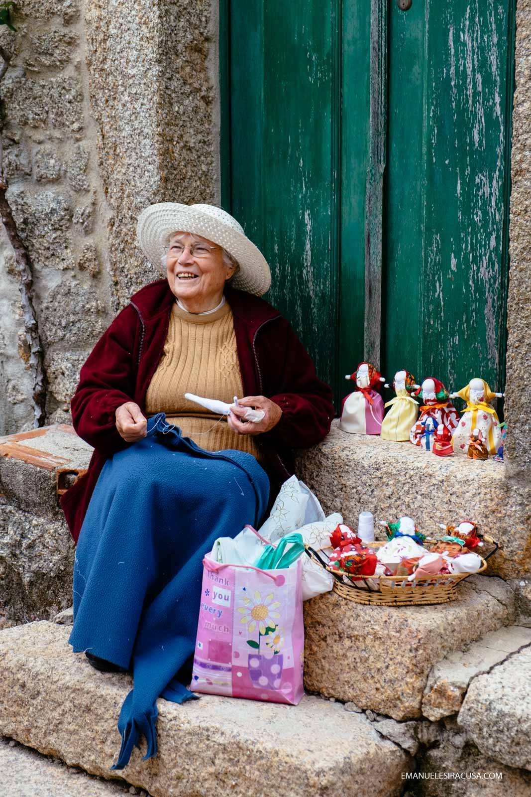 A local elderly lady selling dolls and other hand-made products in the streets of Monsanto, 2016