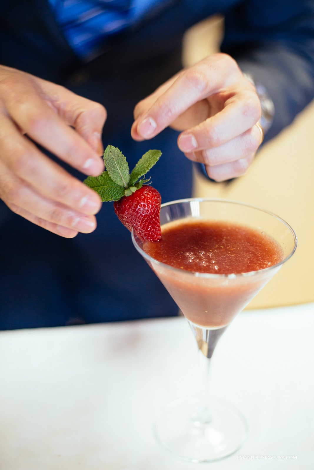 a teacher at the professional school in Fundao gives the finishing touches to a cherry and strawberry based daiquiry cocktail, Fundao, 2016